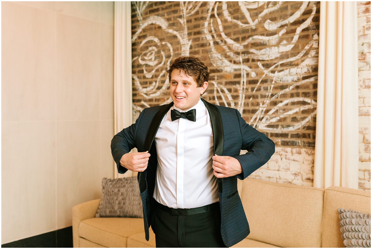 groom gets into custom tux jacket photographed by Chelsea Renay Photography
