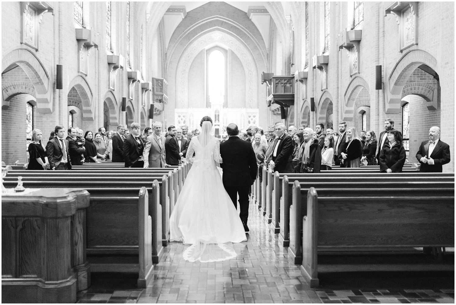 bride and father walk down aisle at church