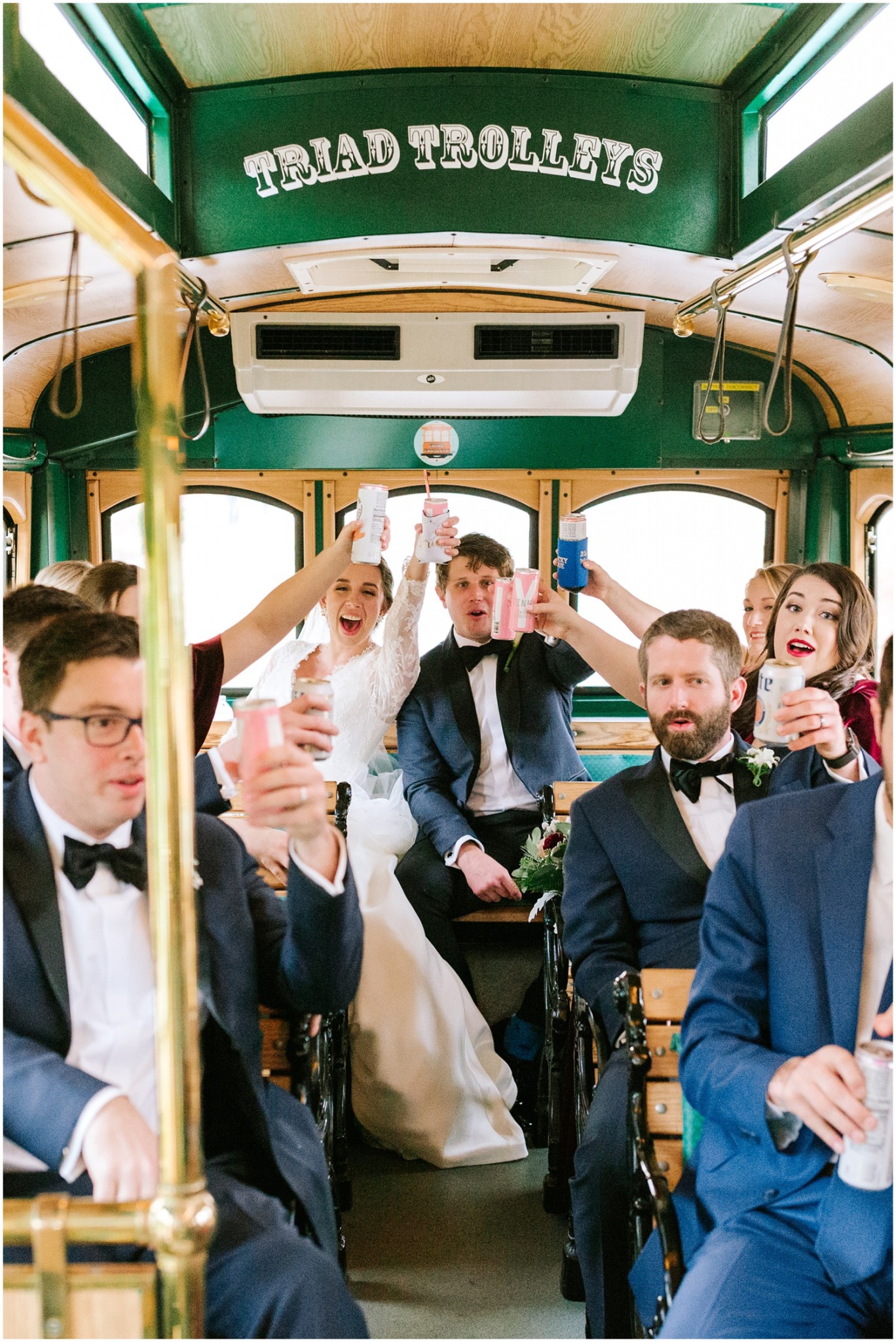 bridal party has a toast on the Triad Trolley photographed by Chelsea Renay Photography