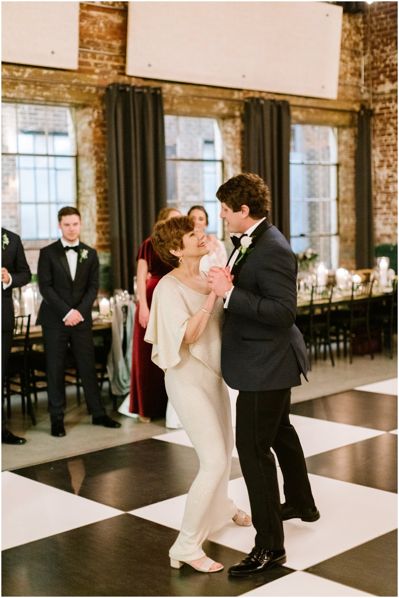 mother and son dance during wedding reception at the Cadillac Service Garage