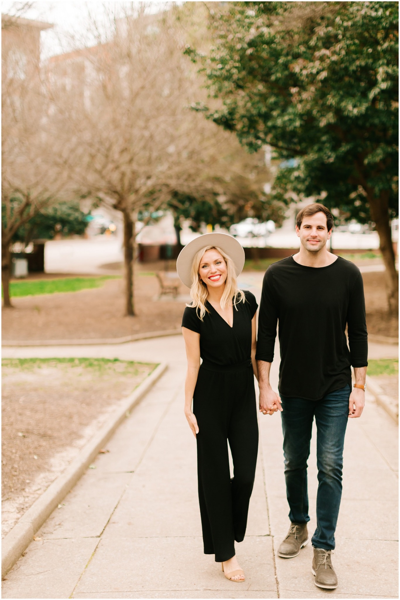 couple walks towards Chelsea Renay in jumpsuit and jeans