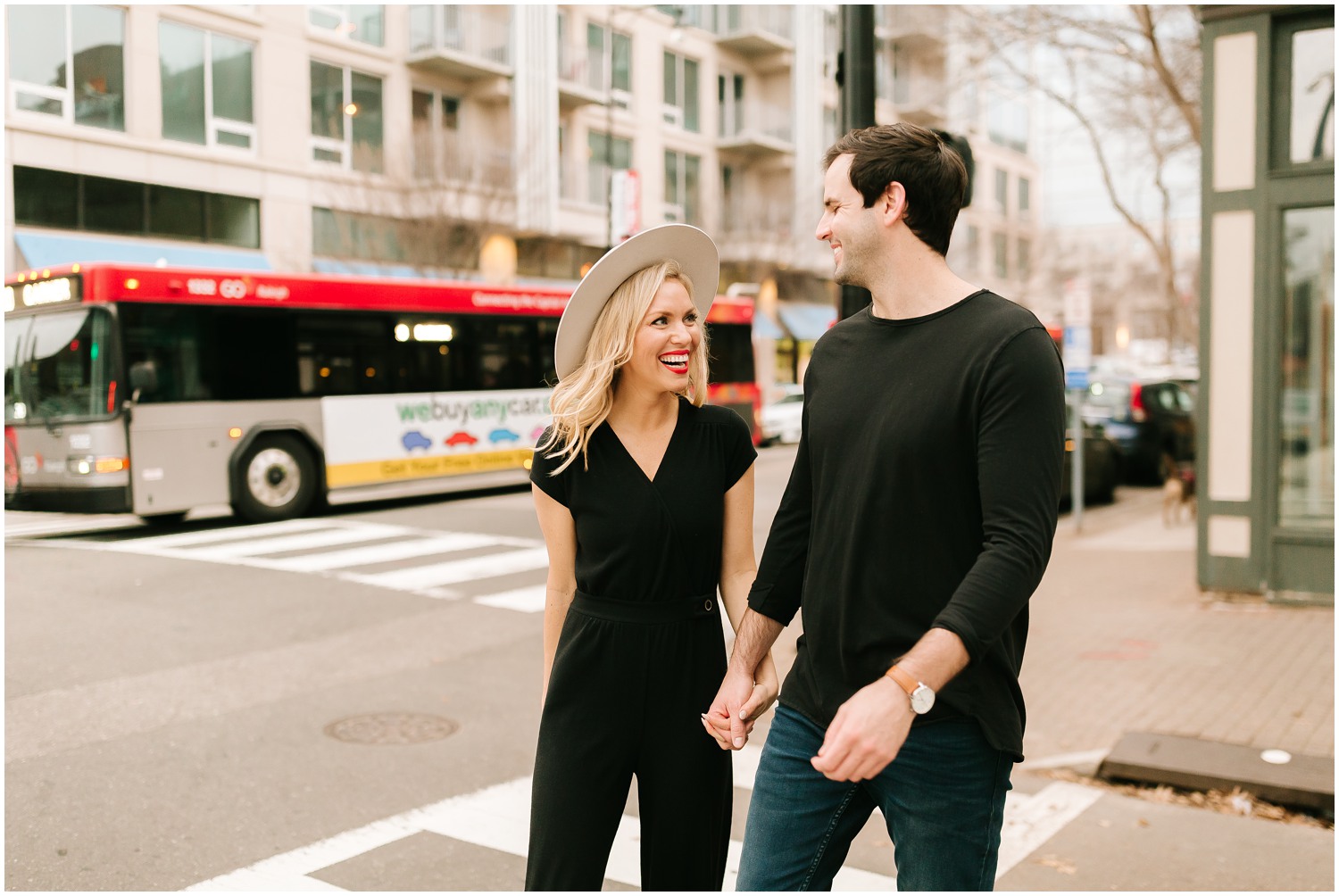 bride wears wide brimmed hat during Downtown Raleigh Engagement Session