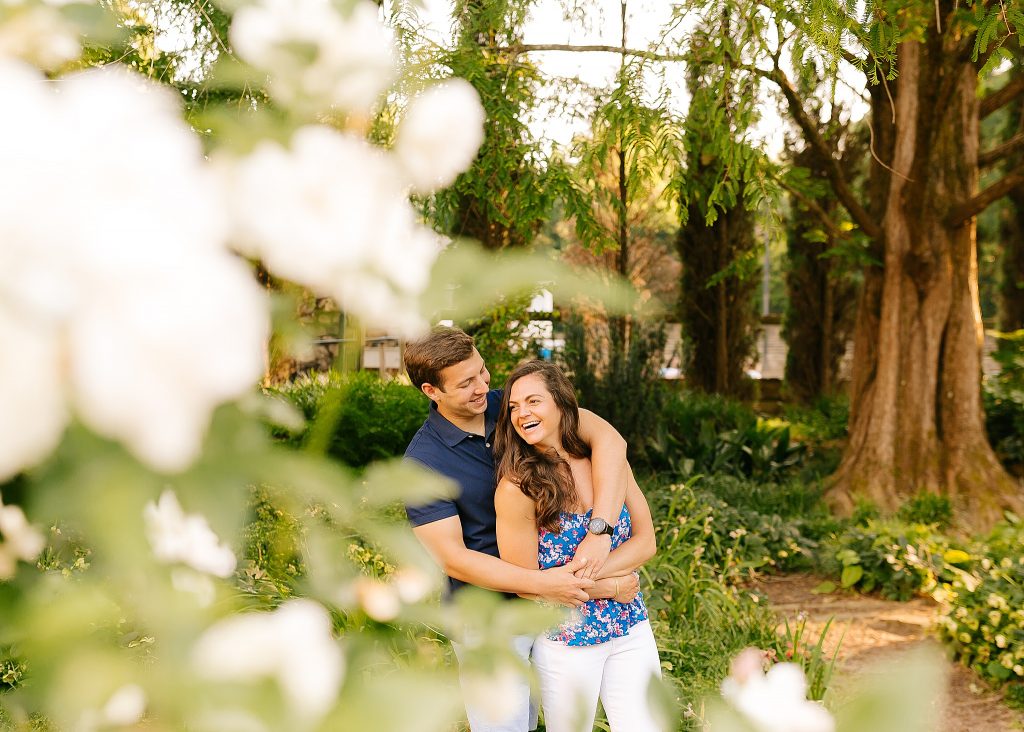bride and groom laugh while hugging at Raleigh Rose Garden