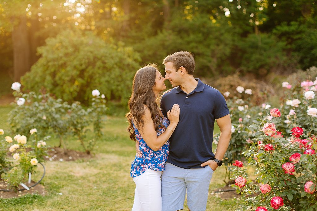 bride and groom touch noses during sunset engagement photos at Raleigh Rose Garden