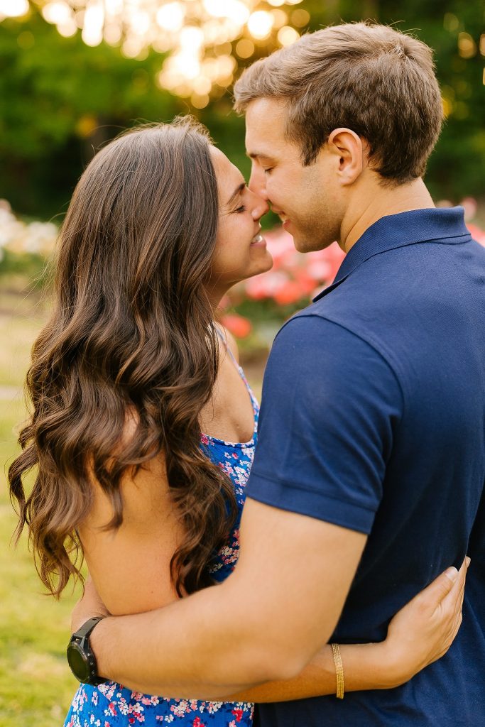 engaged couple kisses at Raleigh Rose Garden photographed by Chelsea Renay