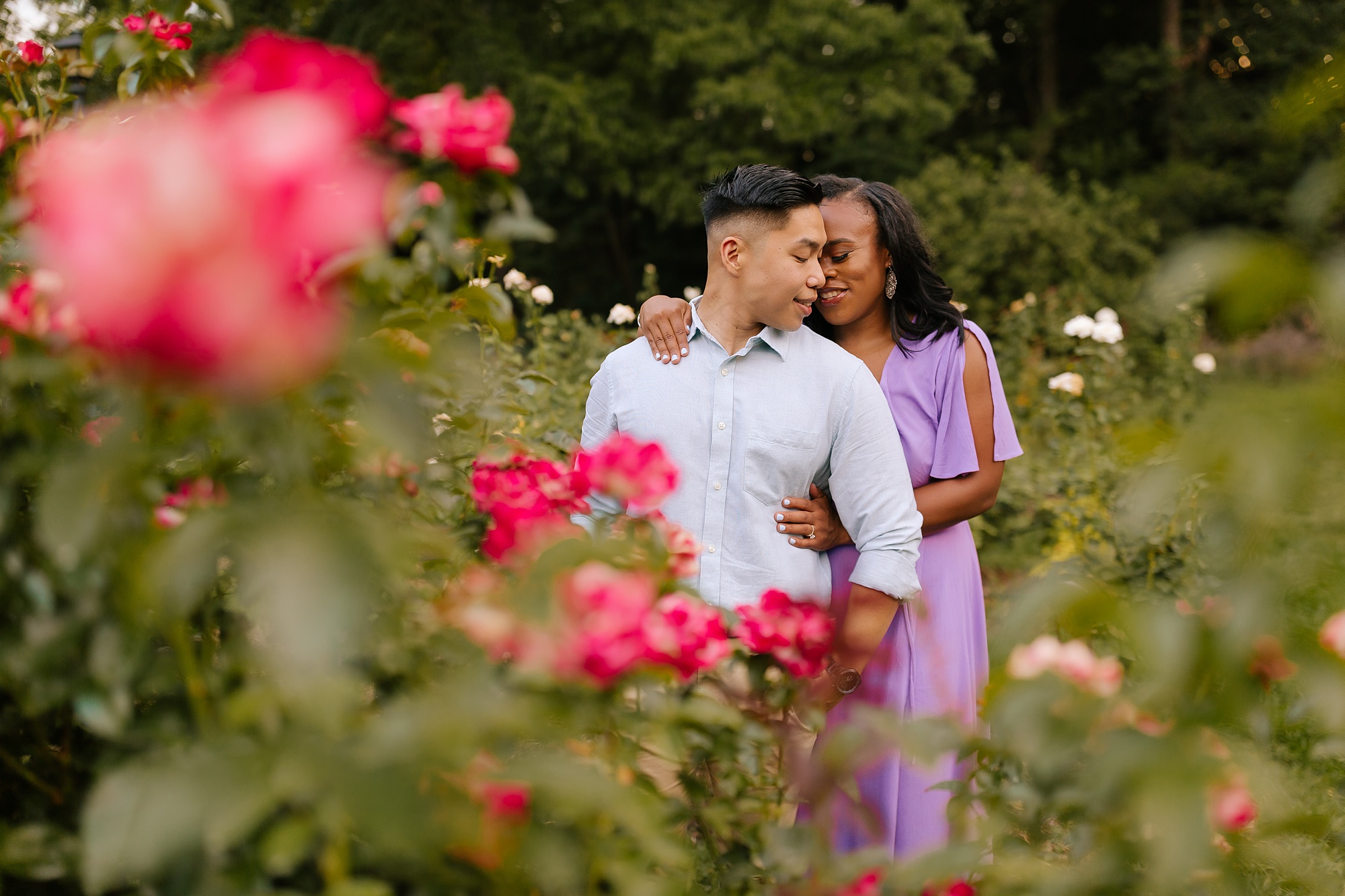 summer WRAL Gardens engagement photos with bride in purple dress