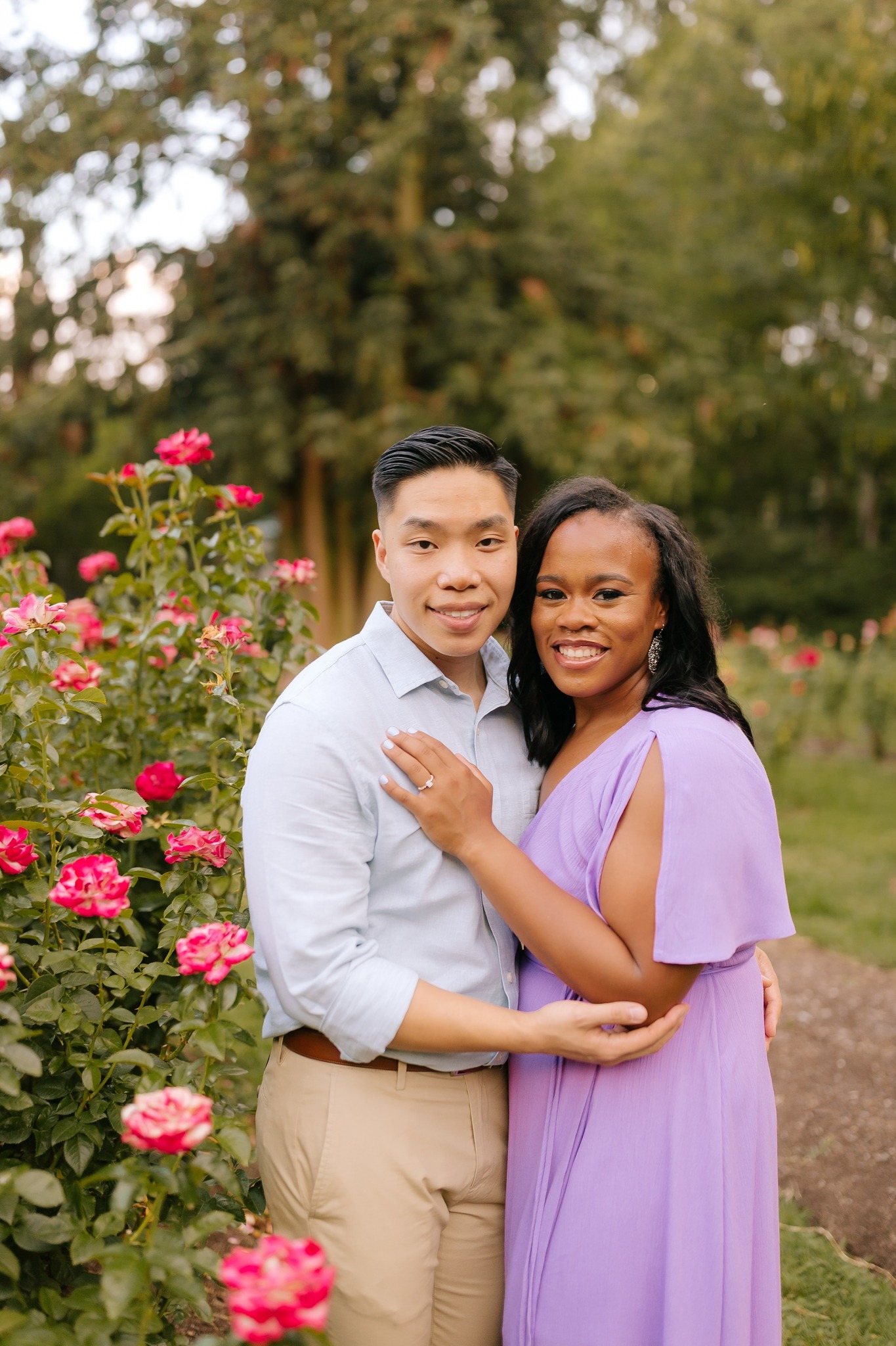 couple poses in rose garden at WRAL Gardens