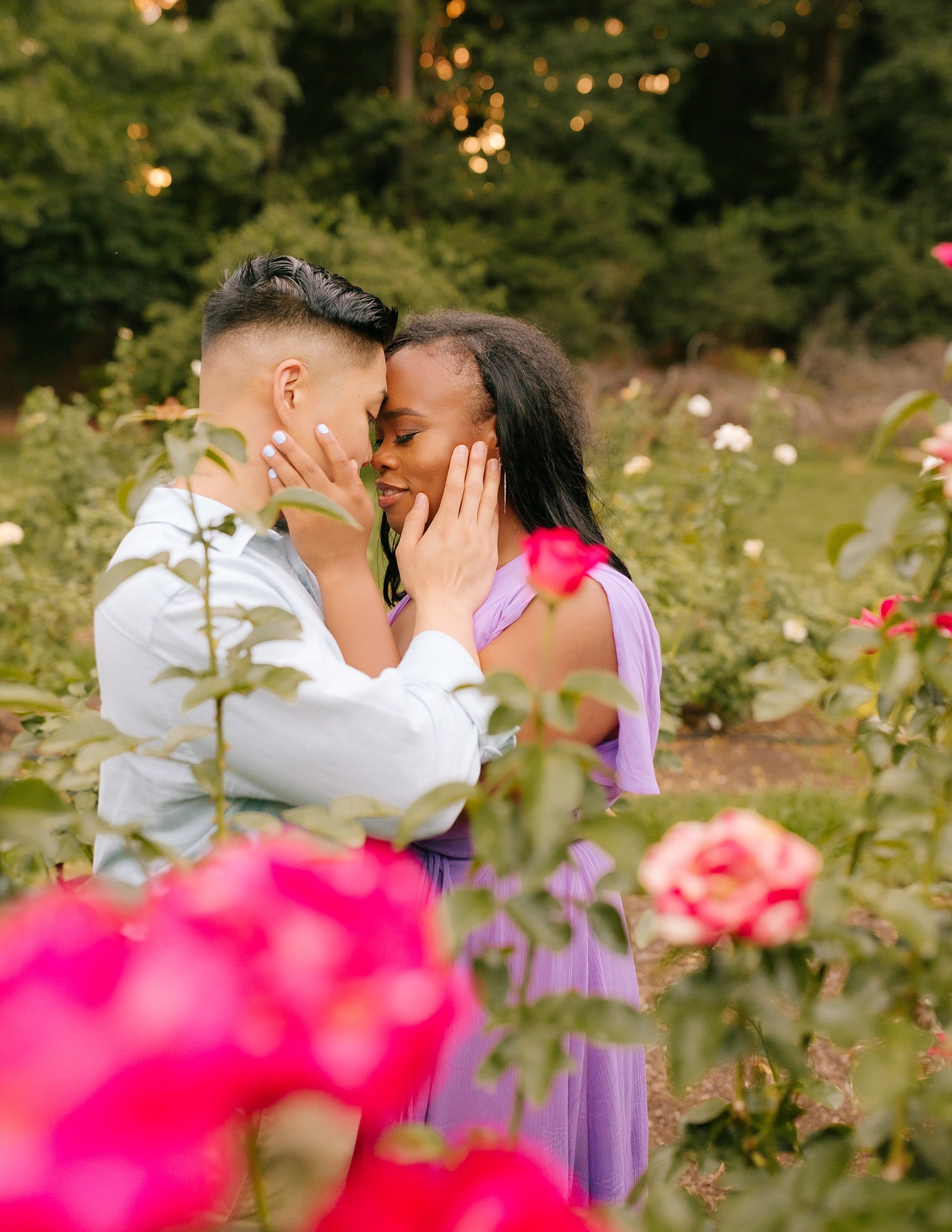 couple kisses during engagement session at Raleigh Rose Garden