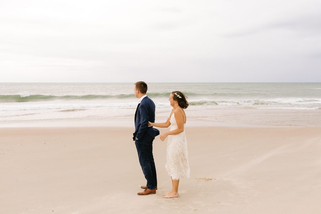 bride taps groom during first look on Ocracoke Island