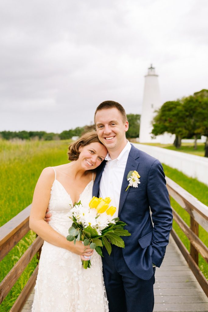 bride and groom relax on walkway up to Ocracoke Lighthouse