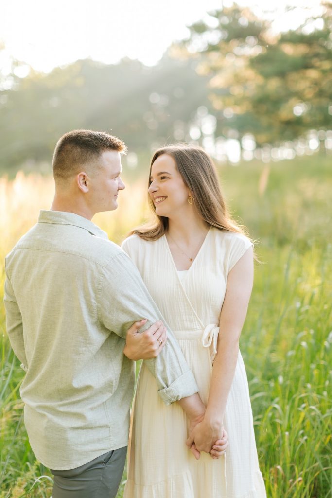 bride and groom smile at each other during engagement session