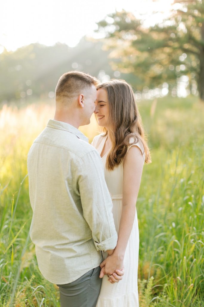 engaged couple touch noses during morning engagement session