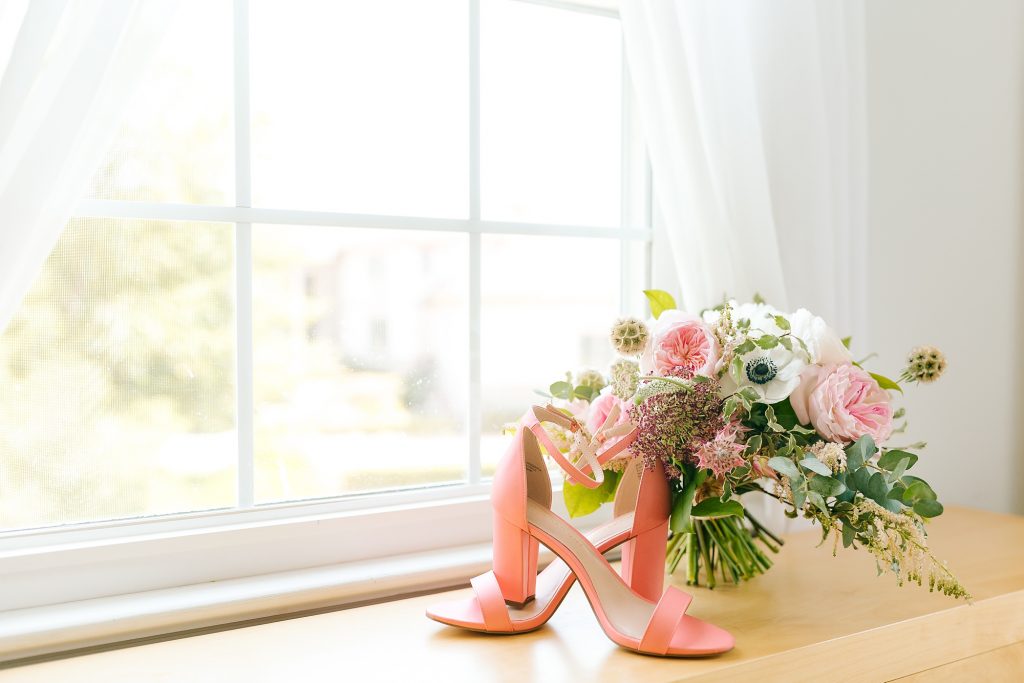 bride's pink heels with bouquet in childhood home