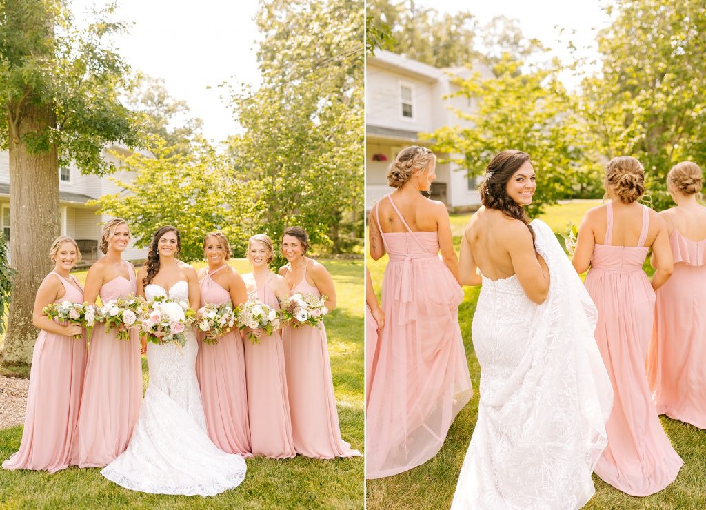 bridesmaids in pale pink gowns walk through backyard