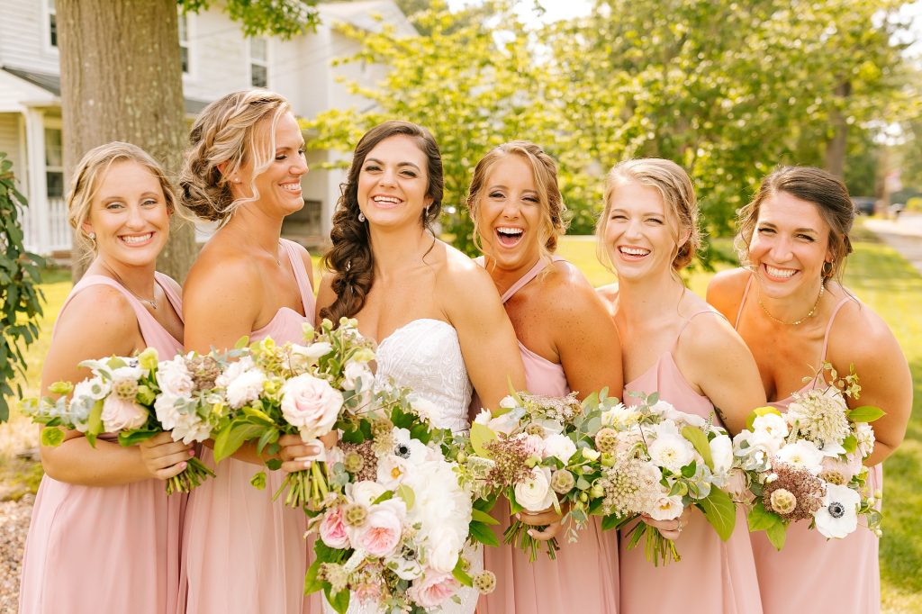 bridesmaids laugh with NJ bride on backyard wedding day