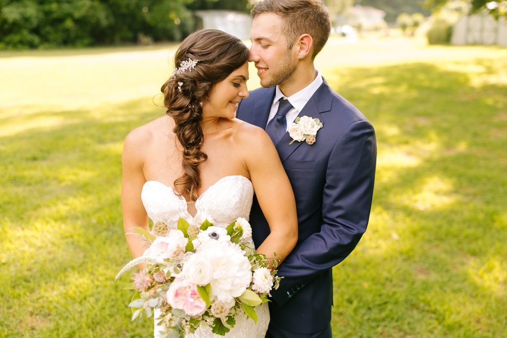 groom nuzzles bride's forehead during wedding portraits
