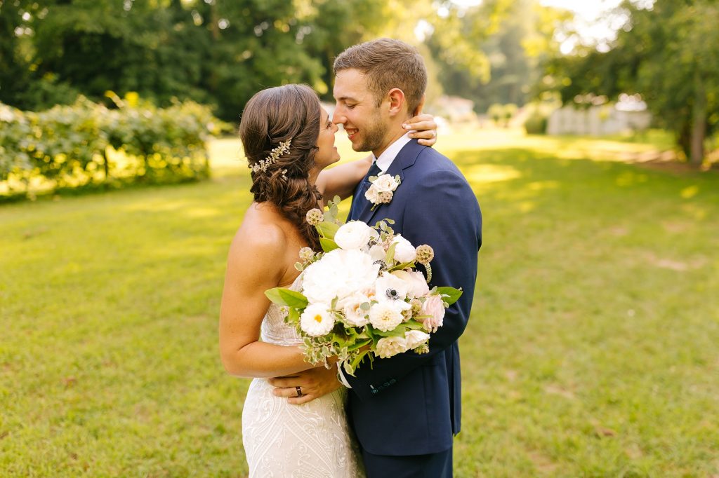 bride and groom touch noses during wedding portraits in New Jersey