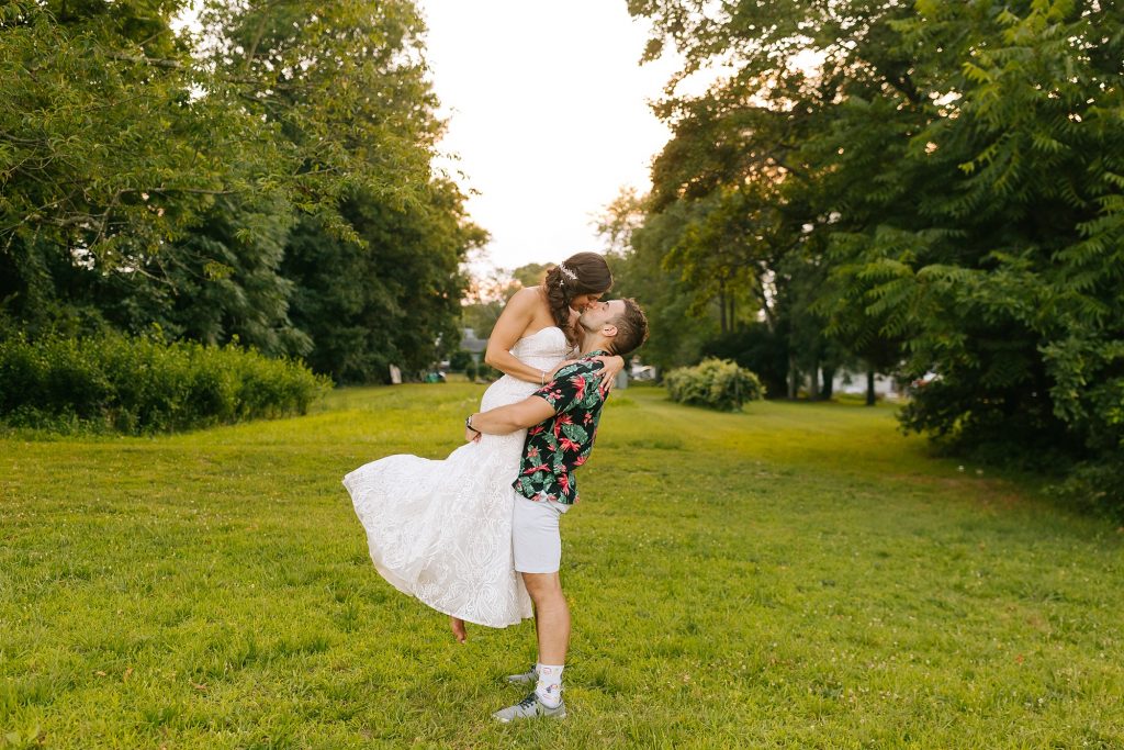 groom lifts bride during New Jersey wedding photos
