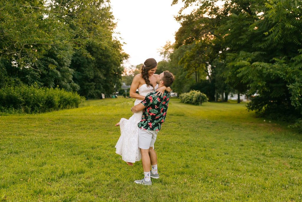 groom lifts bride during New Jersey wedding photos