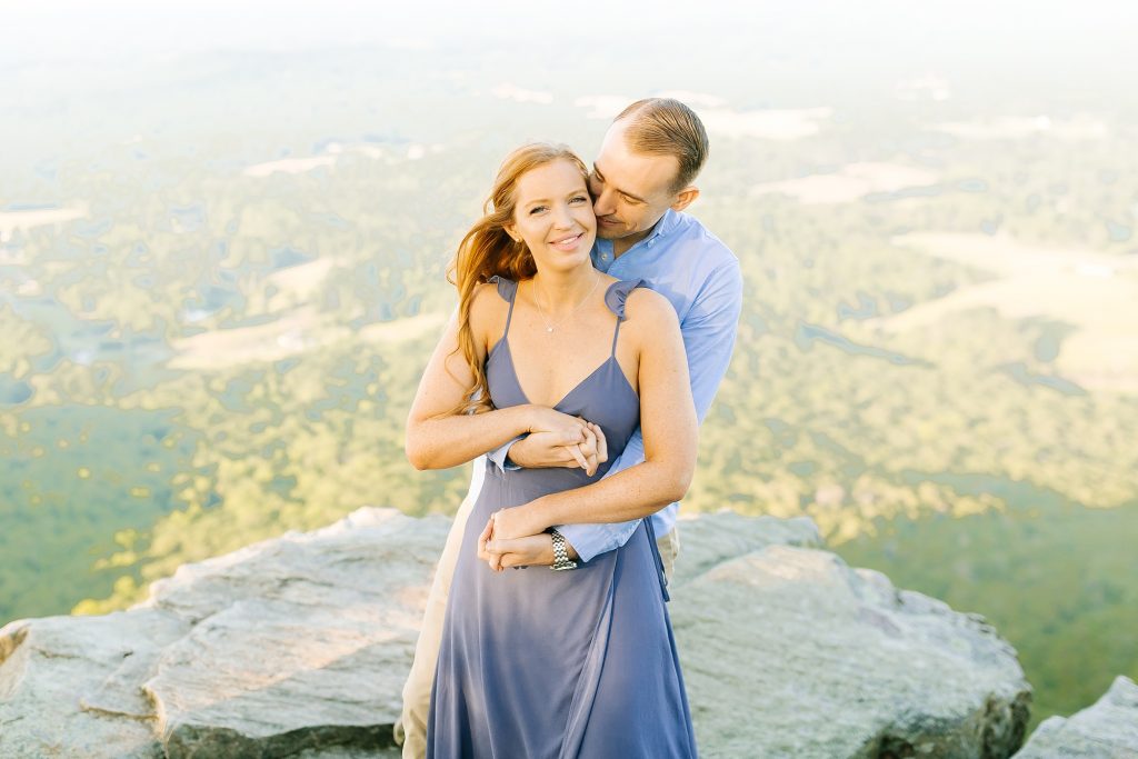 engagement photos in blue outfits on mountaintop in Pinnacle NC