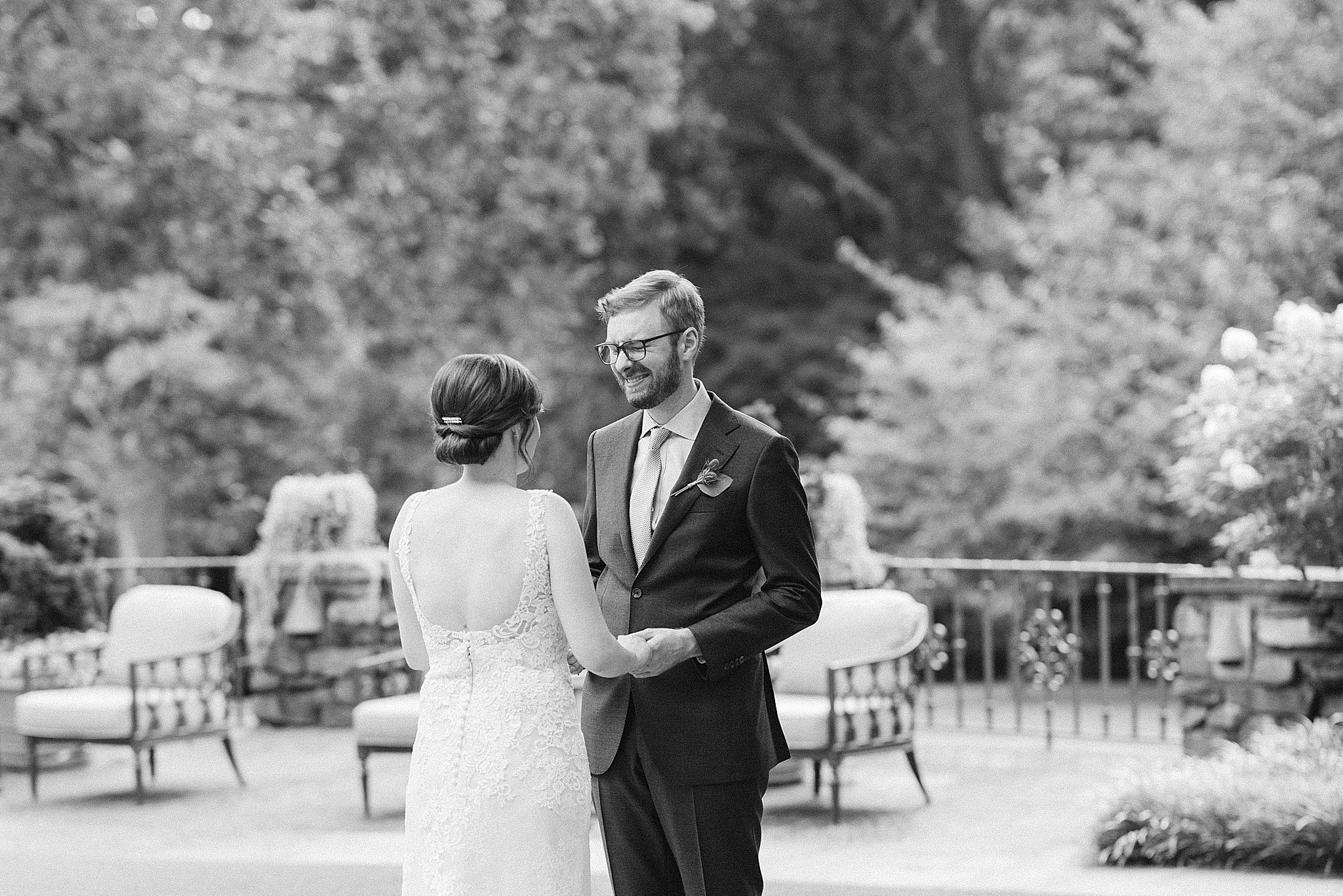 groom smiles at bride during first look before Microwedding at The Graylyn Estate