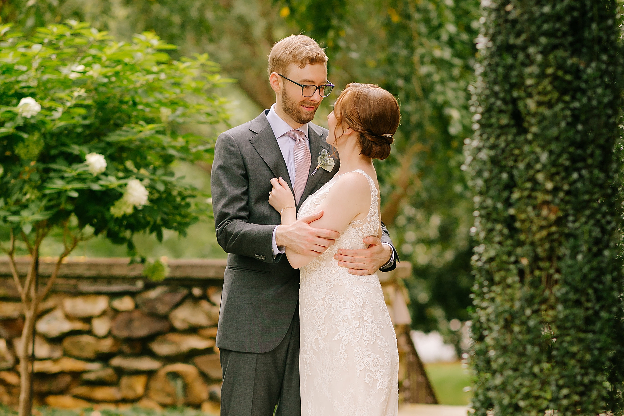 bride and groom hug each other looking at each other