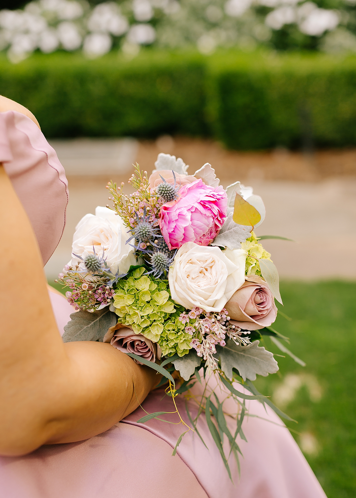 bridesmaid holds bouquet during Graylyn Estate wedding ceremony