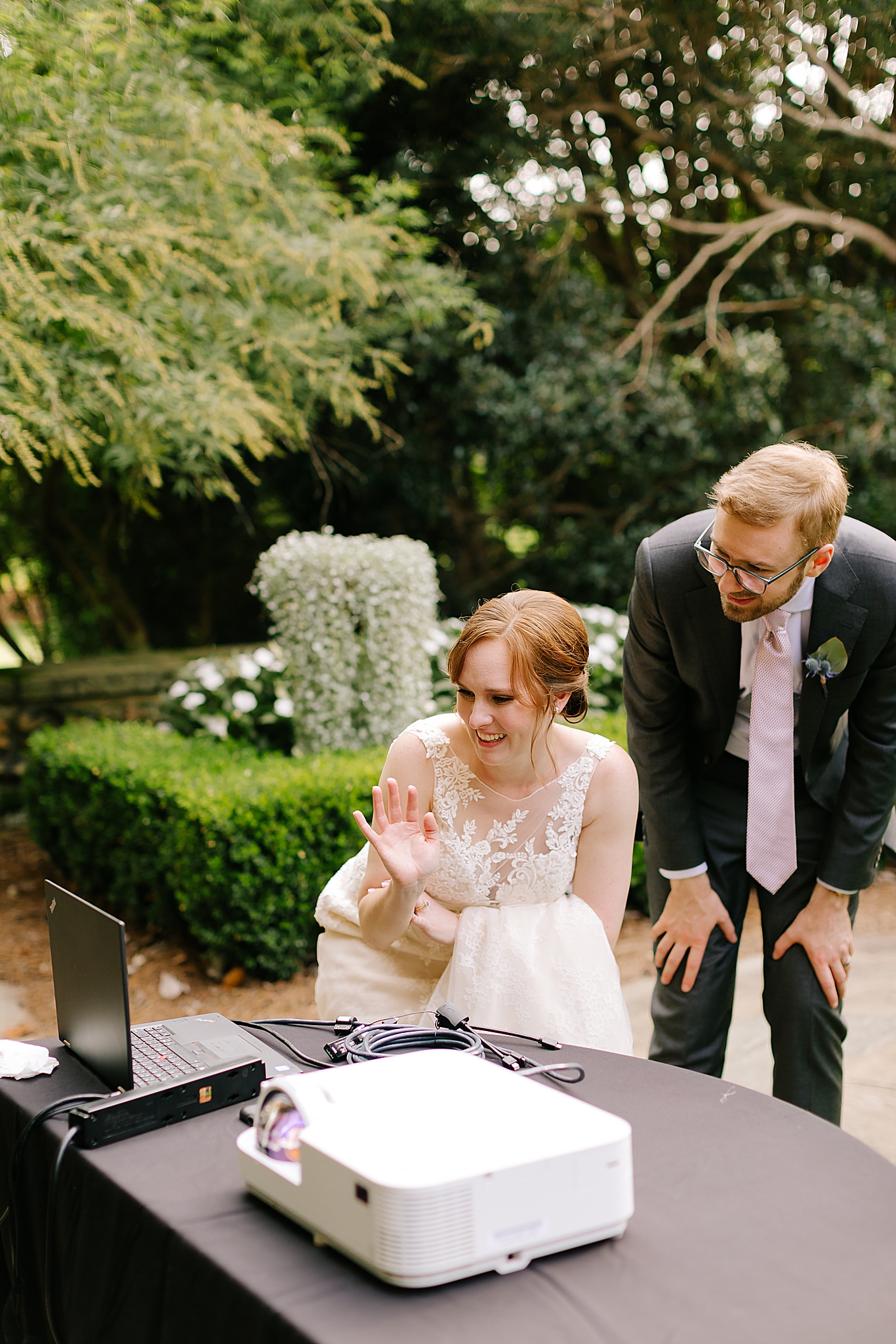 newlyweds waive at guests on video call after Graylyn Estate wedding ceremony