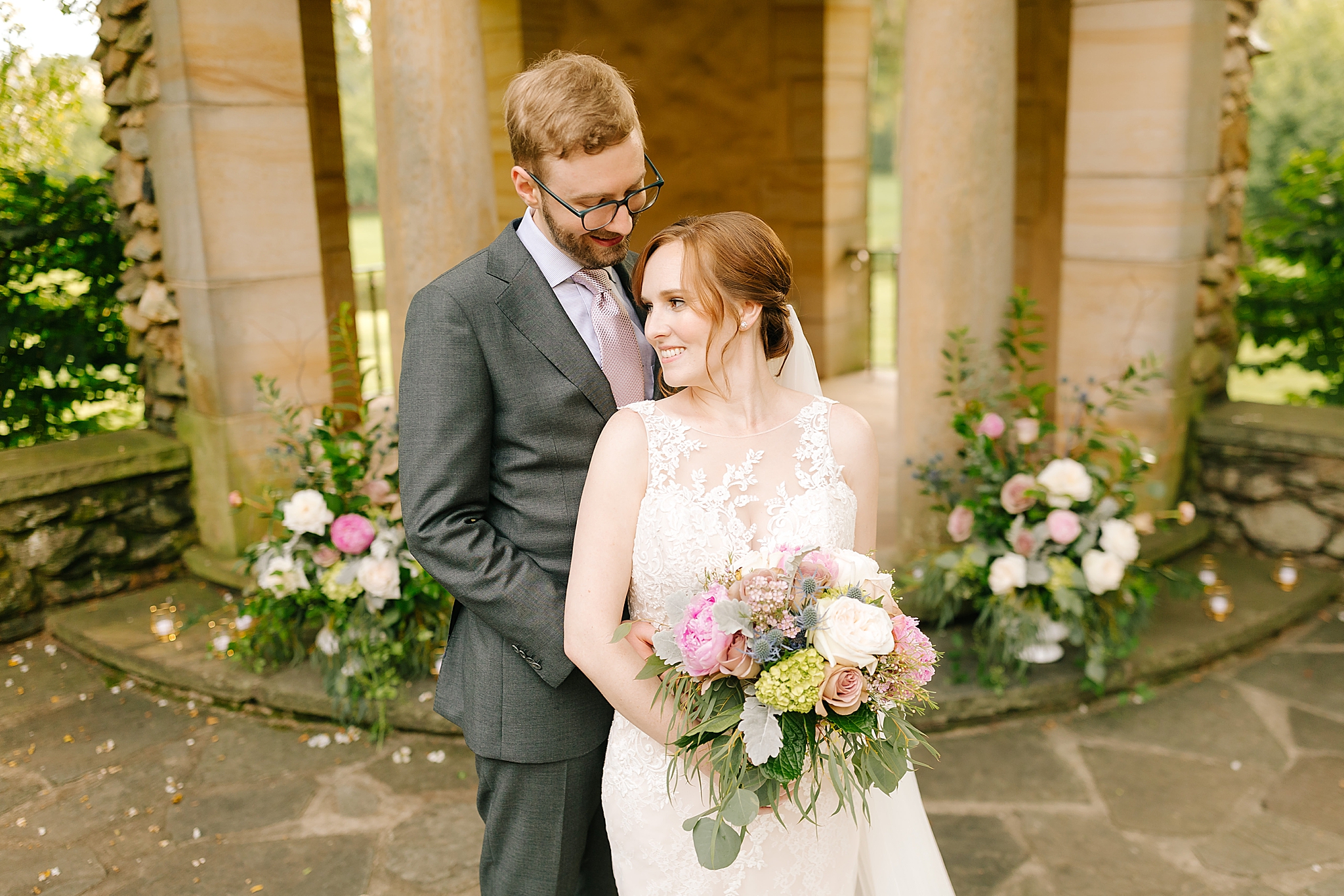 newlyweds pose by gazebo after microwedding at The Graylyn Estate