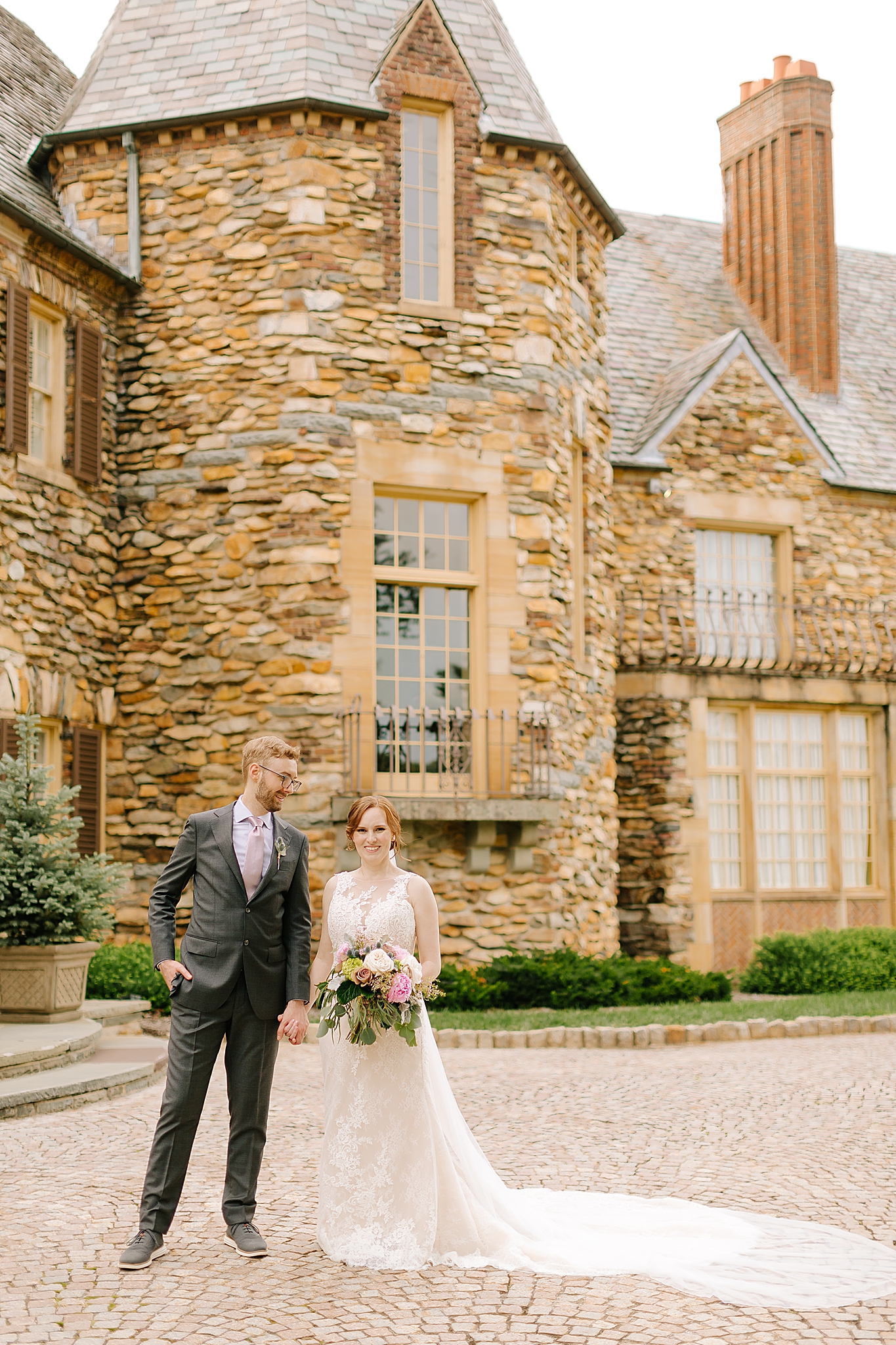 bride and groom pose outside main house at Graylyn Estate