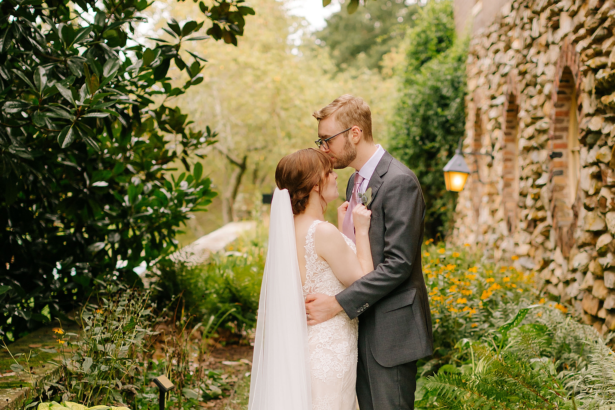 groom kisses bride on the forehead at Graylyn Estate