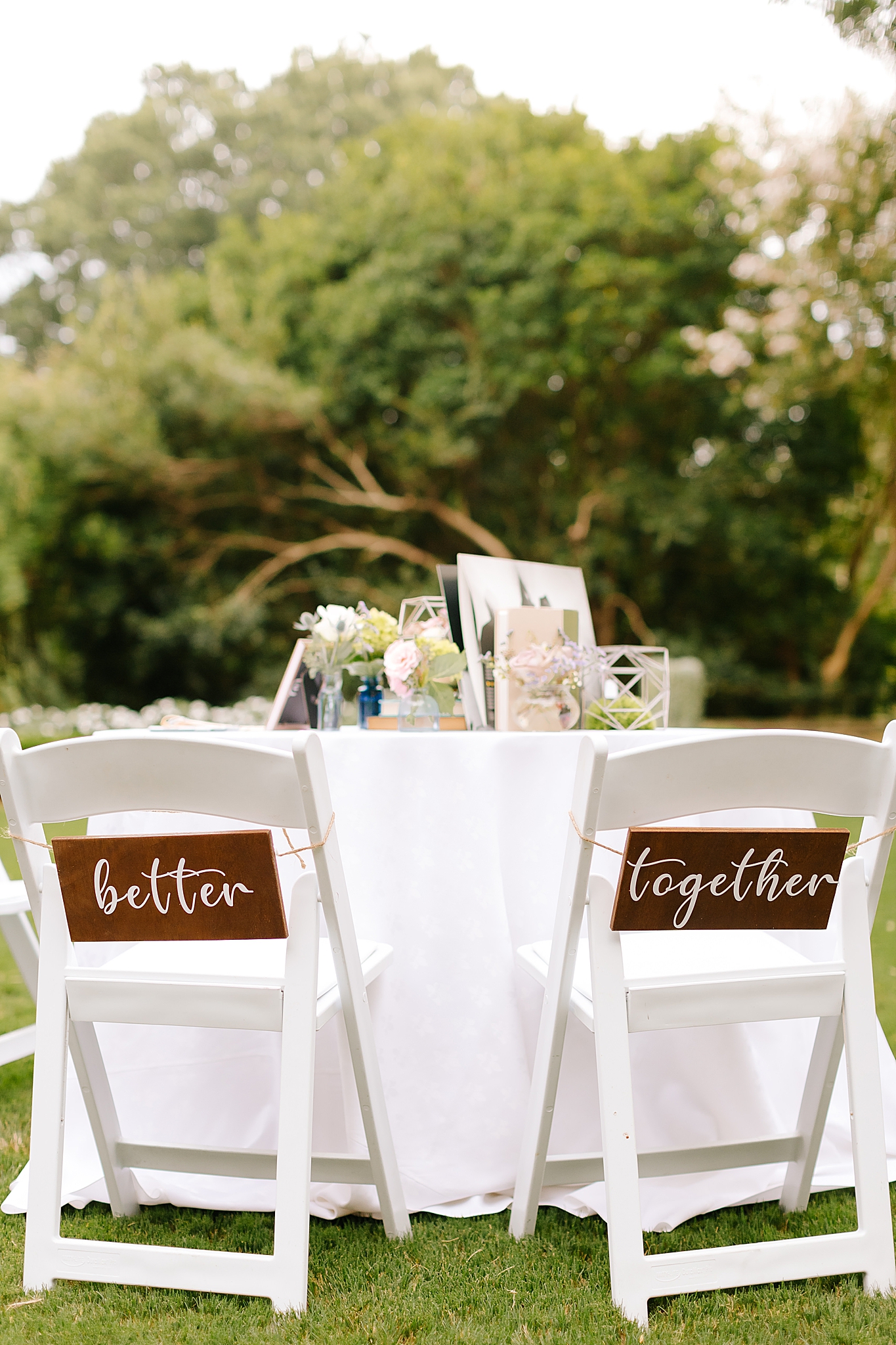 sweetheart table with wooden signs on chairs