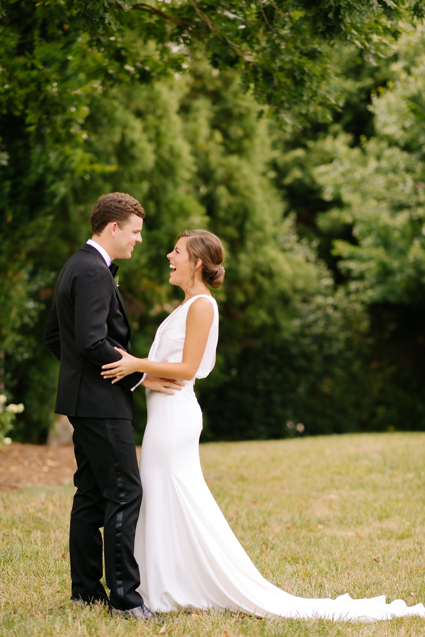 bride and groom laugh during uptown Charlotte first look