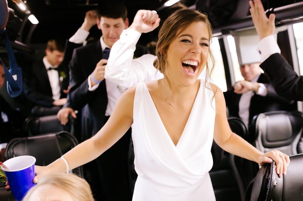 bride laughs during party bus ride in Charlotte