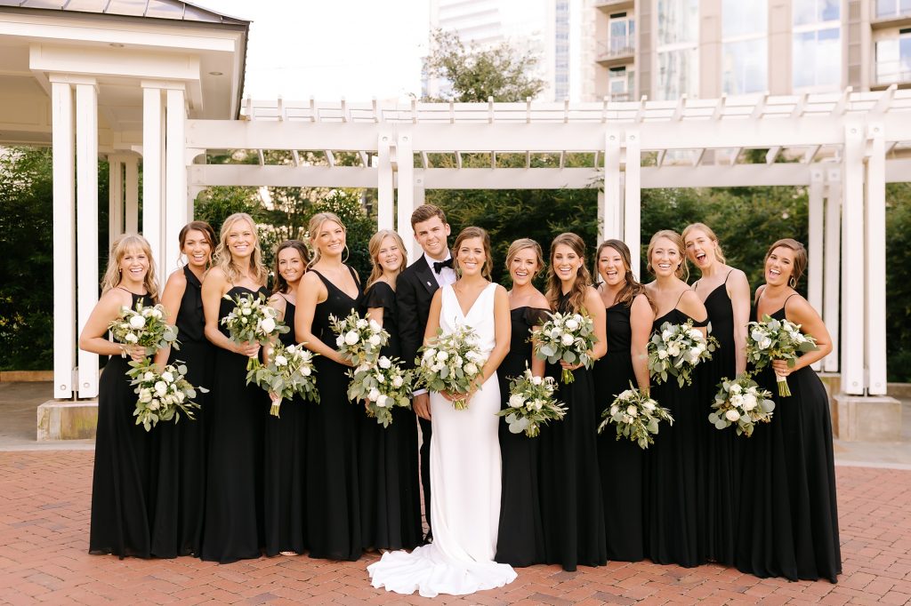 bride and groom pose with bridesmaids