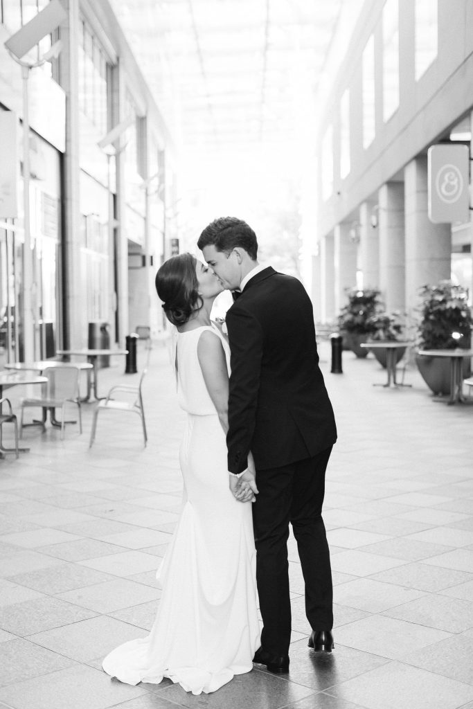 bride and groom kiss after microwedding in Uptown Charlotte