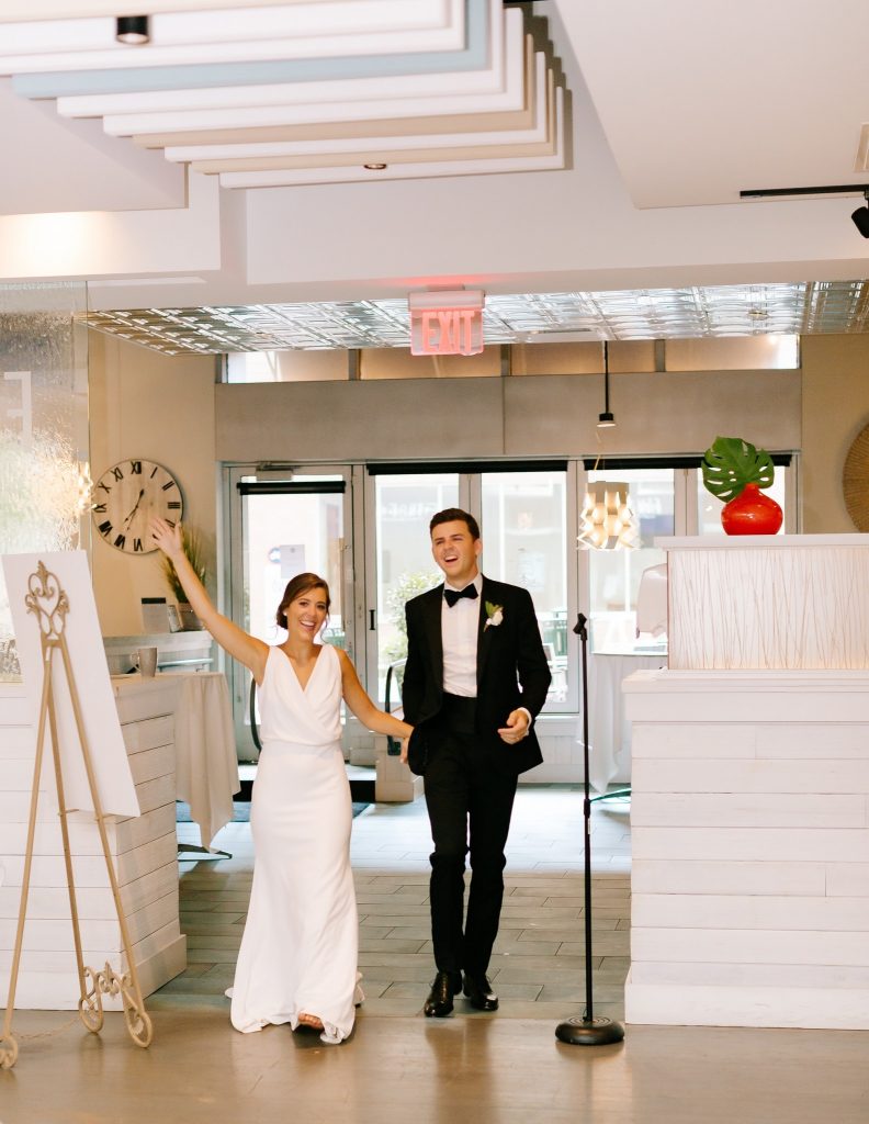 newlyweds enter Fin & Fino wedding reception