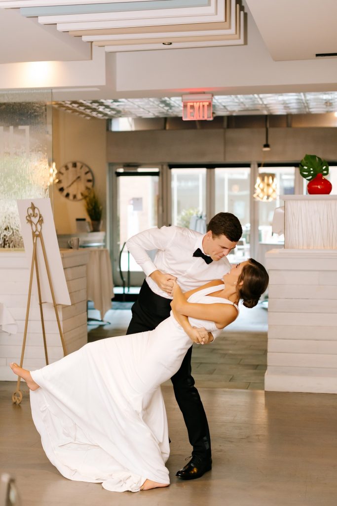 groom dips bride during microwedding reception in Uptown Charlotte