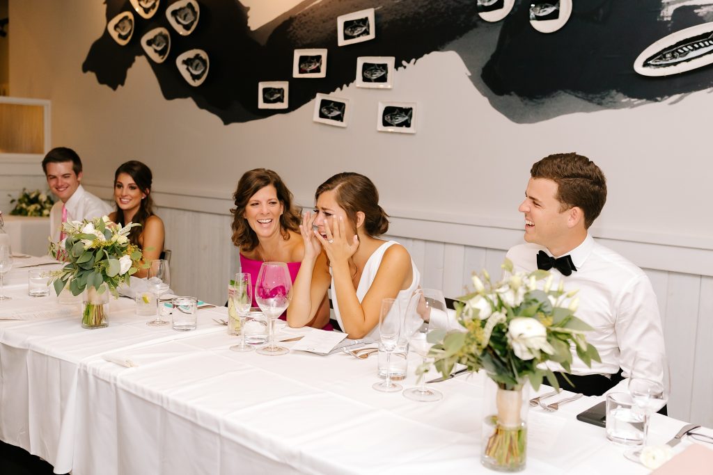 bride cries during toasts at Uptown Charlotte wedding reception