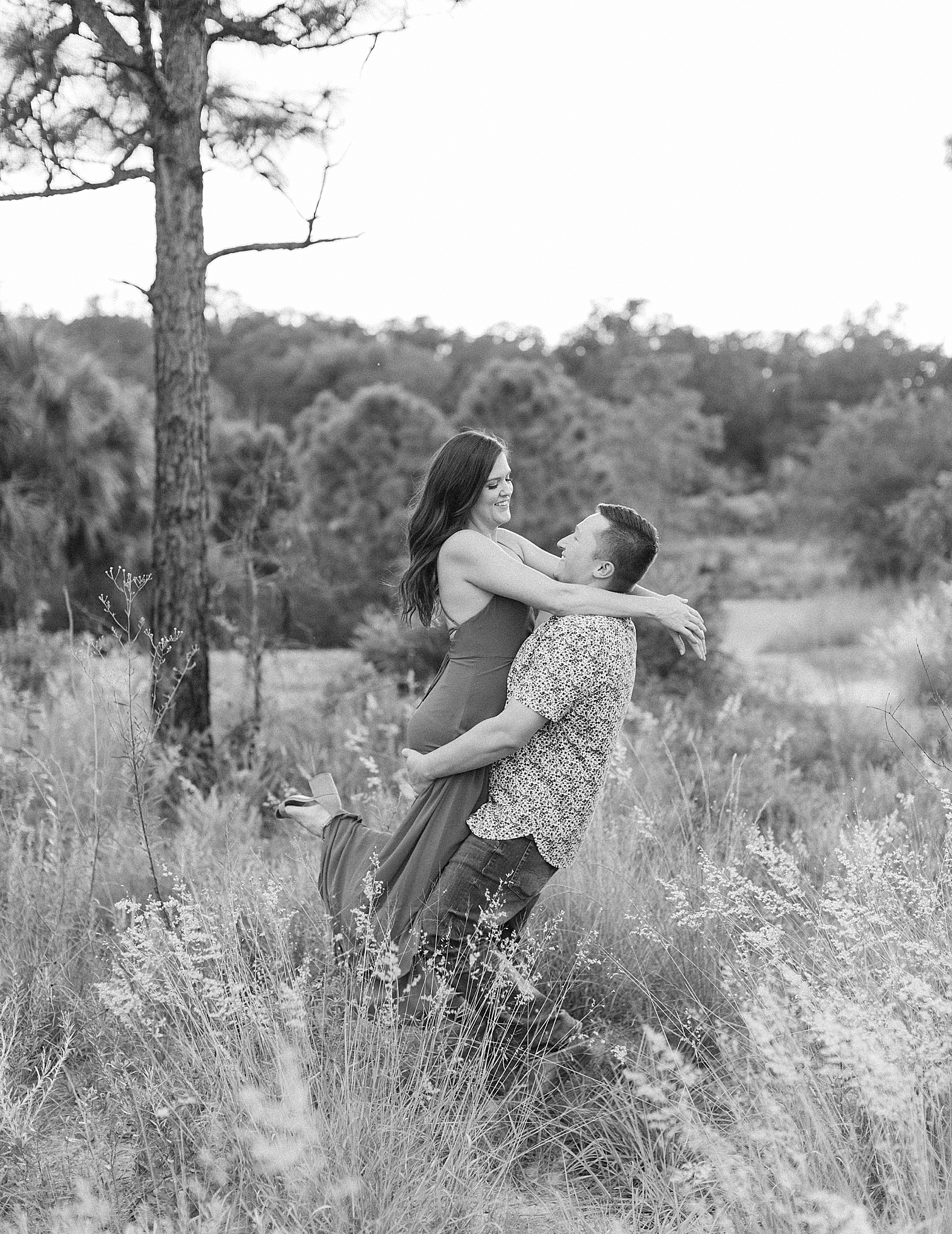 groom lifts bride to be during Bok Tower engagement session
