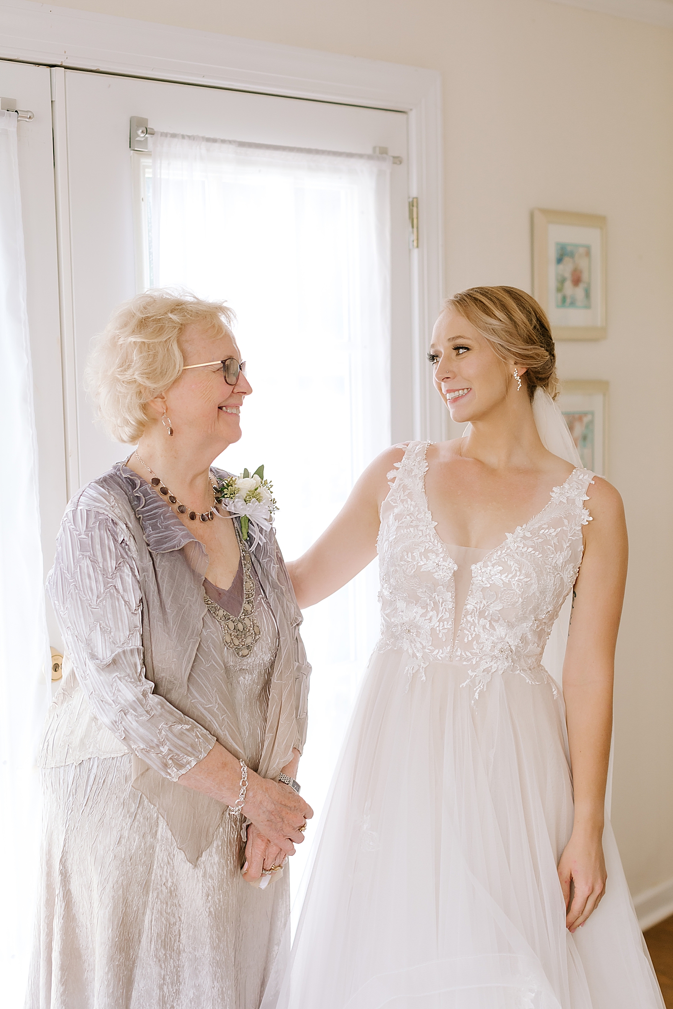 bride shows grandmother wedding gown on morning of wedding