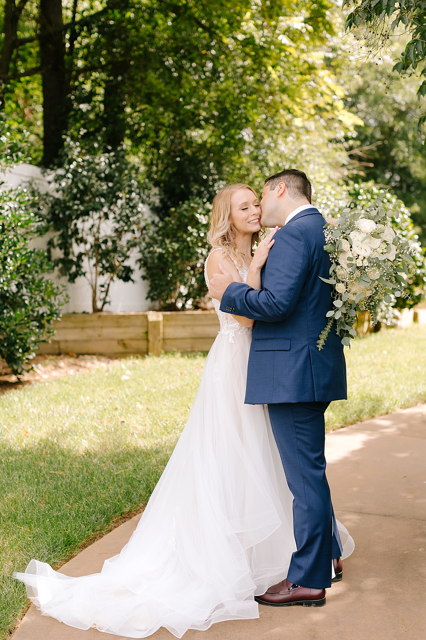 bride and groom kiss during Camellia Gardens wedding