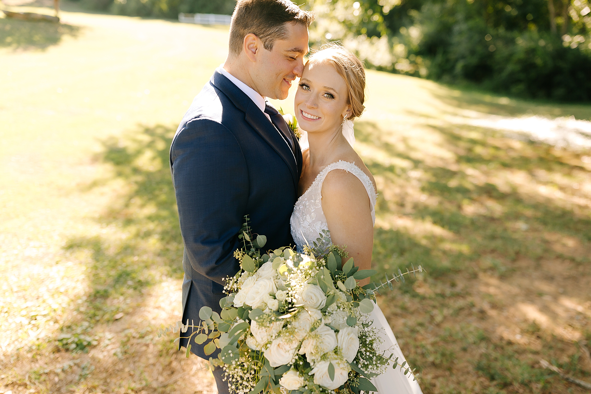 groom nuzzles bride forehead during Camellia Gardens wedding portraits 