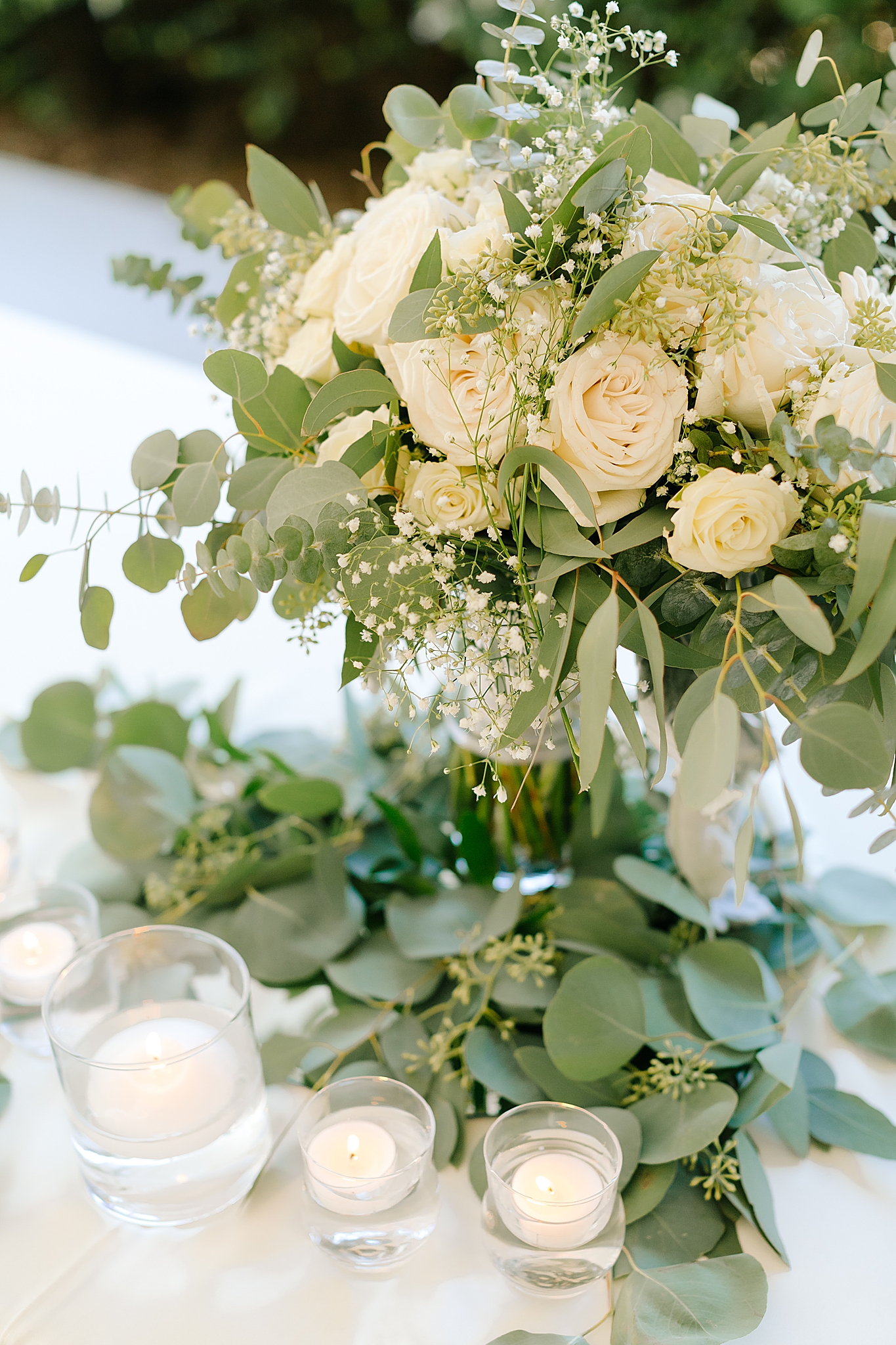 centerpieces with ivory roses and eucalyptus 