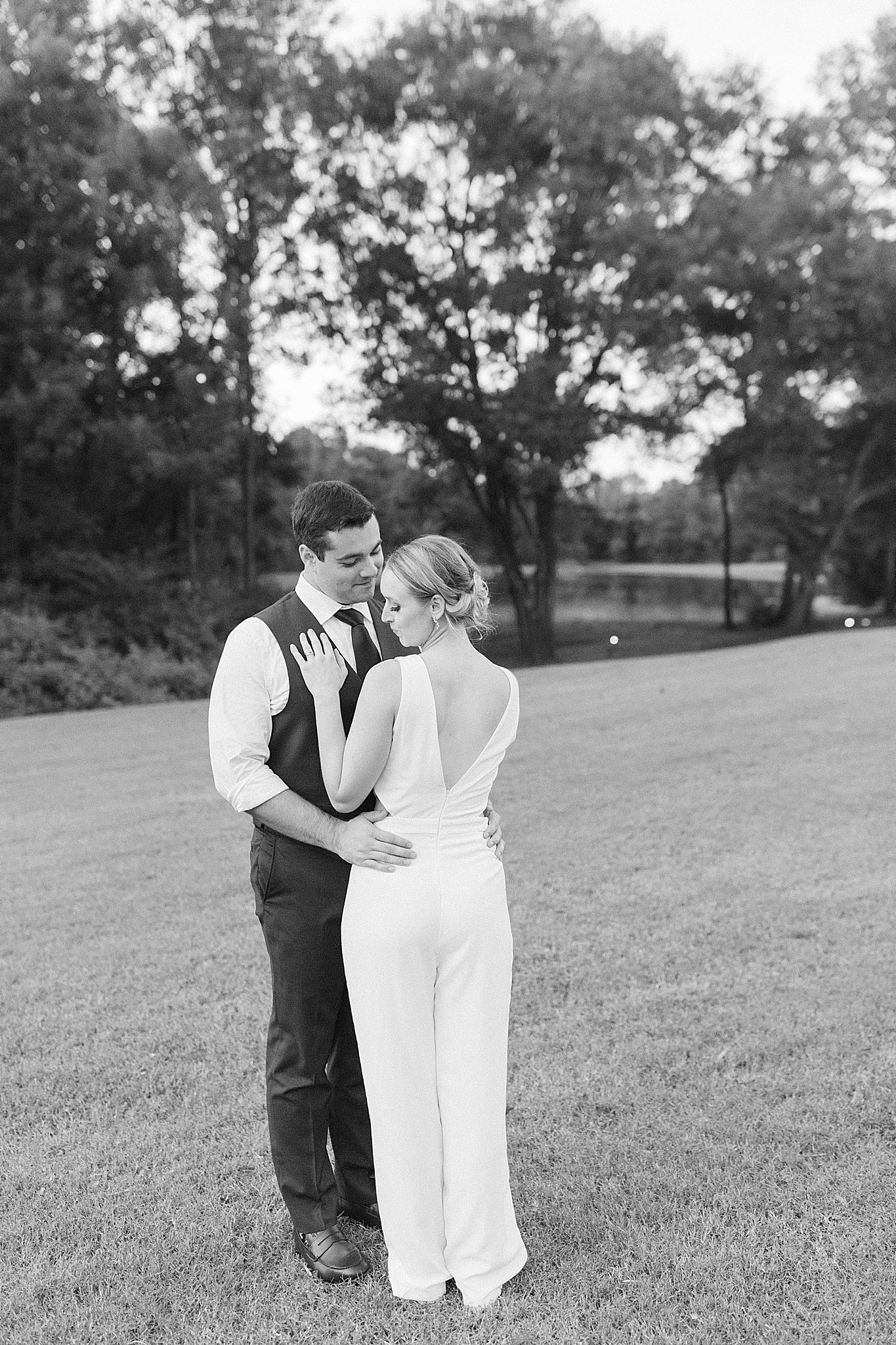 Monroe NC wedding portraits of groom and bride in jumpsuit