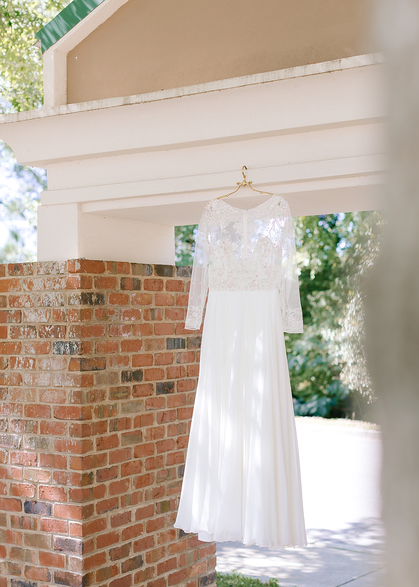 wedding dress hangs in doorway at Southern Charm Events