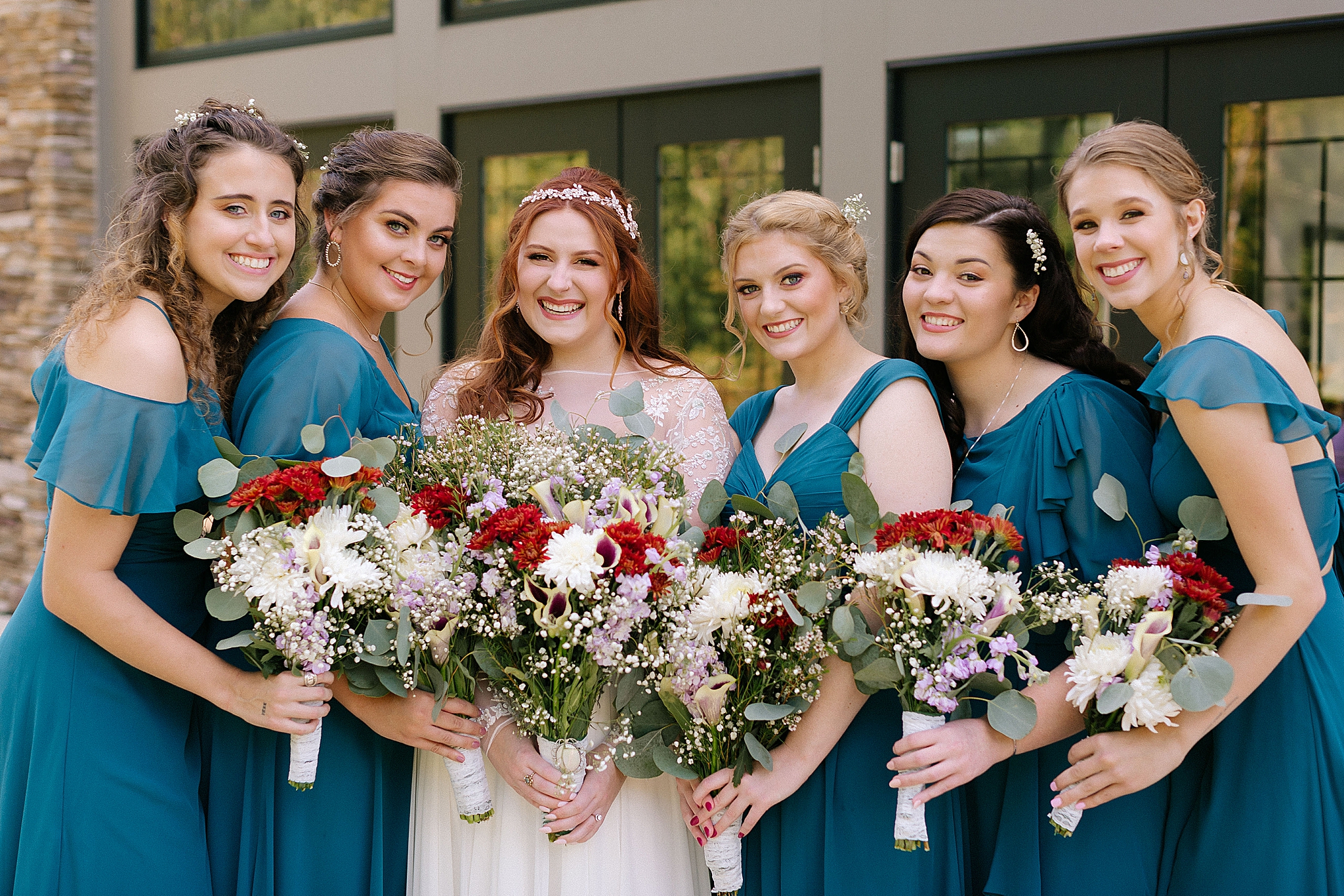 bridesmaids hold bouquets with bride at Southern Charm Events
