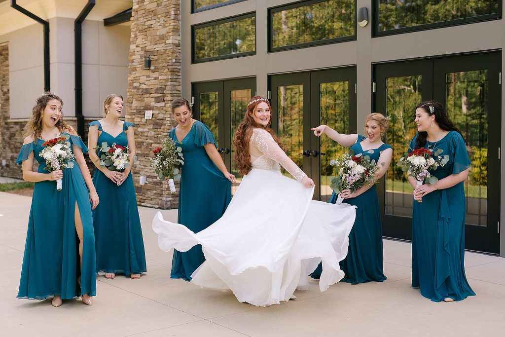 bride twirls wedding dress for bridesmaids