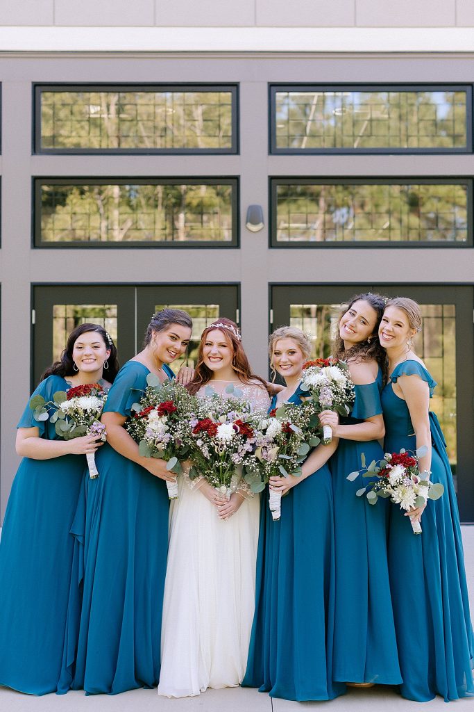 bridesmaids in teal gowns pose with bride in Rock Hill SC