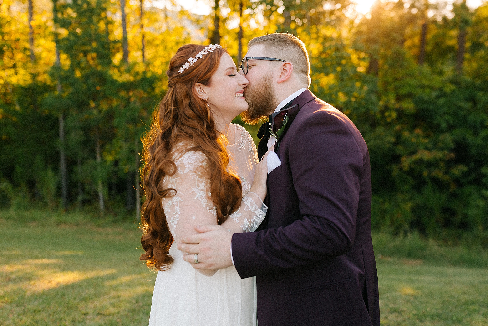 groom kisses bride on the cheek during sunset wedding photos